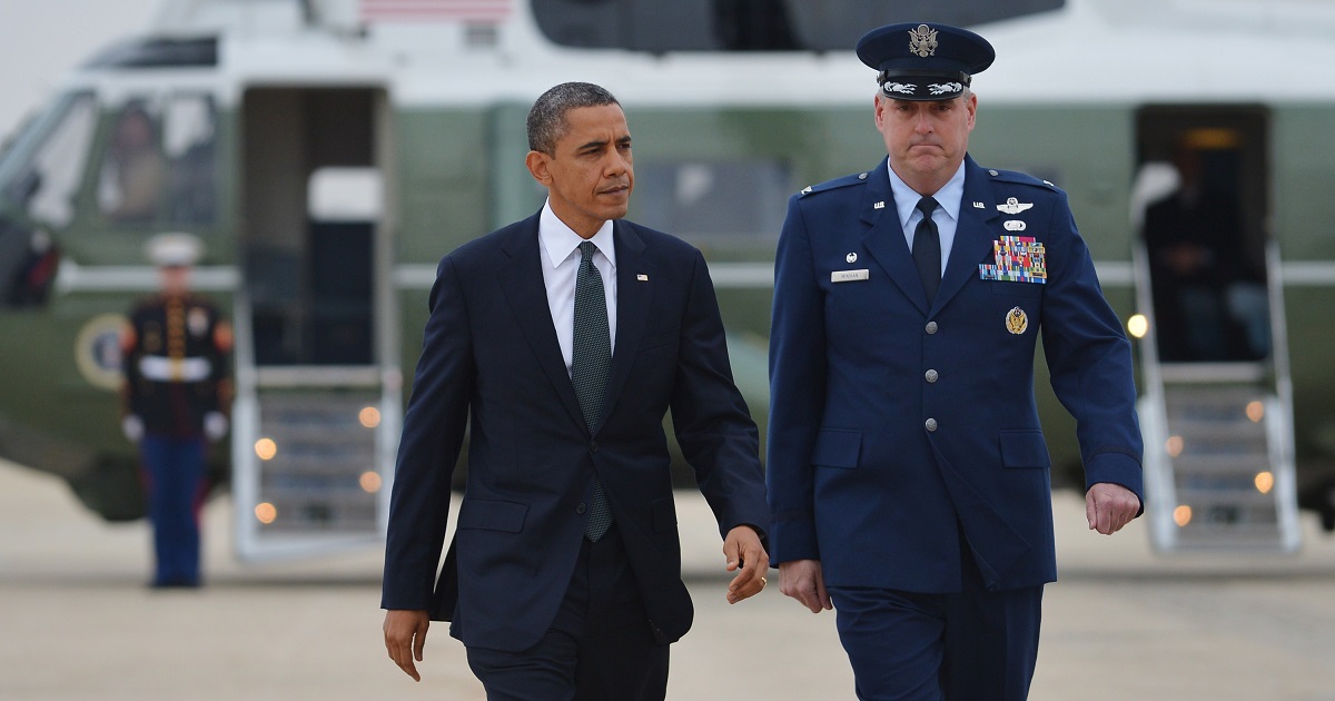 Former President Barack Obama walks with then-Col. Mike Minihan.