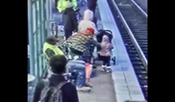 This video screen shot shows a person shoving a child onto train tracks in Portland.