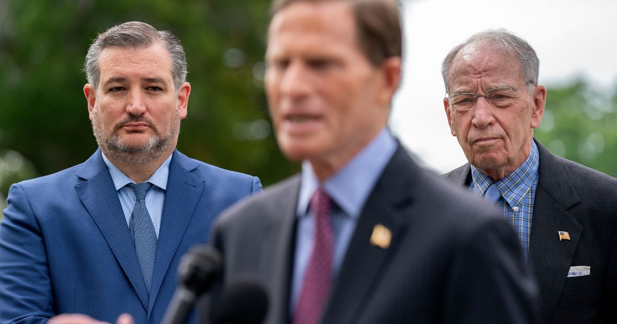 Republicans Sen. Ted Cruz, left, and Sen. Chuck Grassley, right, listen as Democratic Sen. Richard Blumenthal speaks during a news conference outside the U.S. Capitol on April 29, 2021, in Washington, D.C.