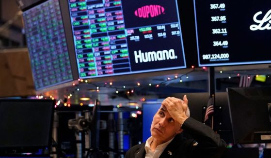 A trader reacts on the floor of the New York Stock Exchange at the closing bell on December 30, 2022 in New York.