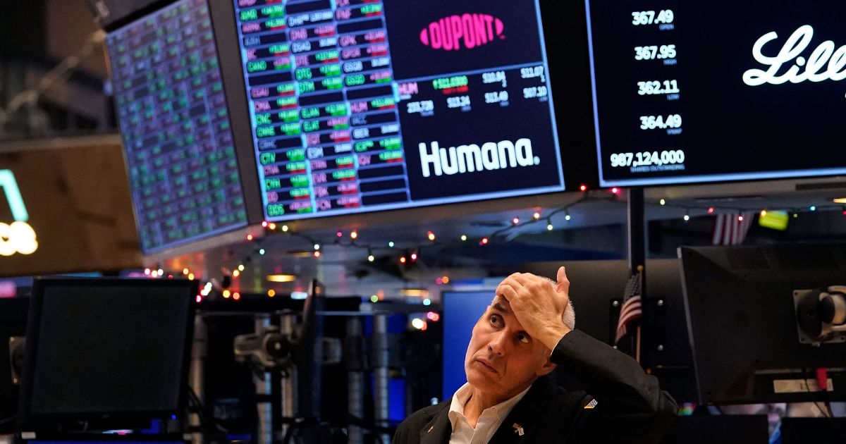 A trader reacts on the floor of the New York Stock Exchange at the closing bell on December 30, 2022 in New York.