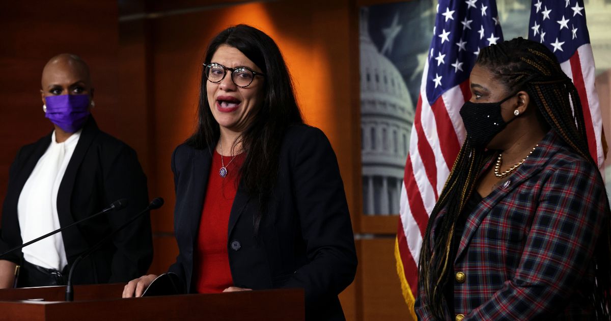 Rep. Rashida Tlaib (D-MI) (2nd L) becomes emotional as she speaks as Rep. Ayanna Pressley (D-MA) (L) and Rep. Cori Bush (D-MO) (R) look on during a news conference at the U.S. Capitol December 8, 2021 in Washington, DC.