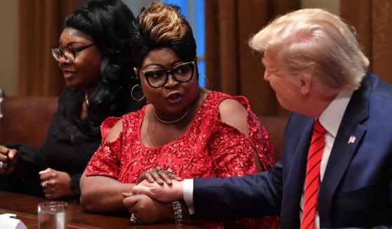 Former President Donald Trump reacts as social media personalities Lynnette Hardaway and Rochelle Richardson, otherwise known as Diamond and Silk, speak during a meeting with African-American leaders in the Cabinet Room of the White House in Washington, D.C., on Feb. 27, 2020.