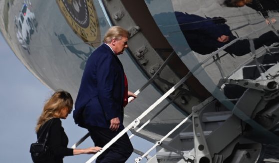 Then-President Donald Trump and then-first lady Melania Trump board Air Force One at Palm Beach International Airport in West Palm Beach, Florida, on Dec. 31, 2020.