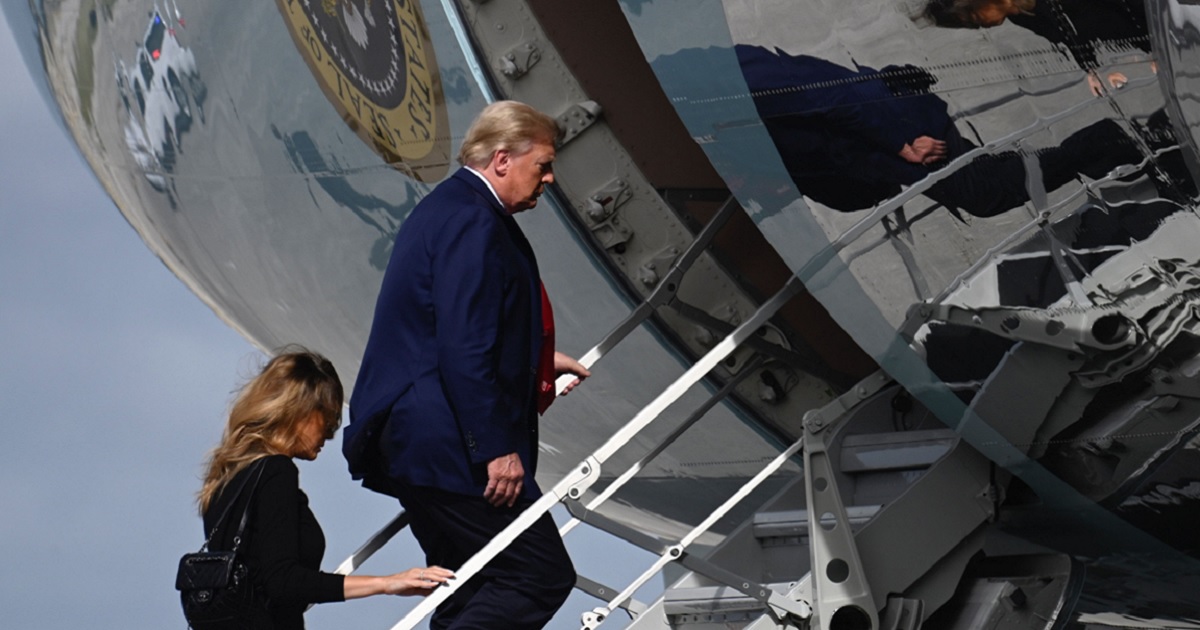 Then-President Donald Trump and then-first lady Melania Trump board Air Force One at Palm Beach International Airport in West Palm Beach, Florida, on Dec. 31, 2020.