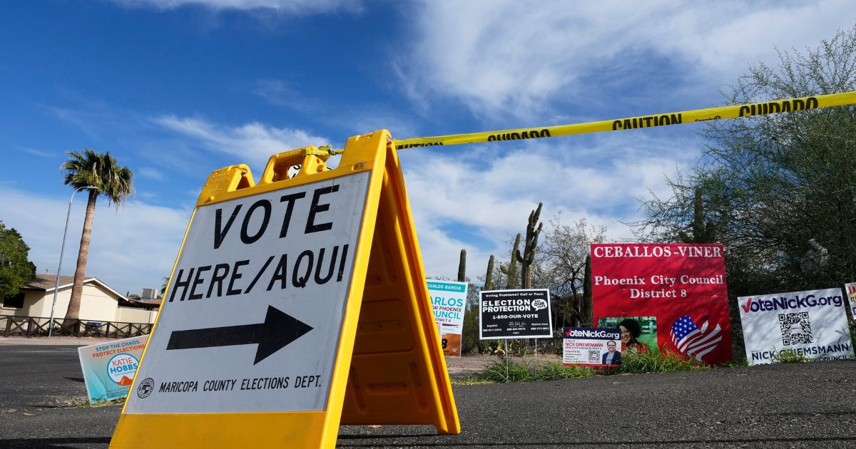 A sign points voters in the right direction to drop off ballots in Phoenix on Nov. 7, 2022.