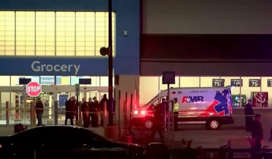 Police and medical personnel are pictured outside a Walmart in Evansville, Indiana, late Thursday after a shooting.