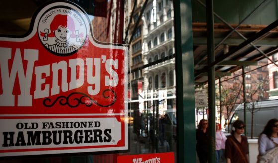 Pedestrians walk by a Wendy's hamburger chain on April 24, 2008, in New York City.