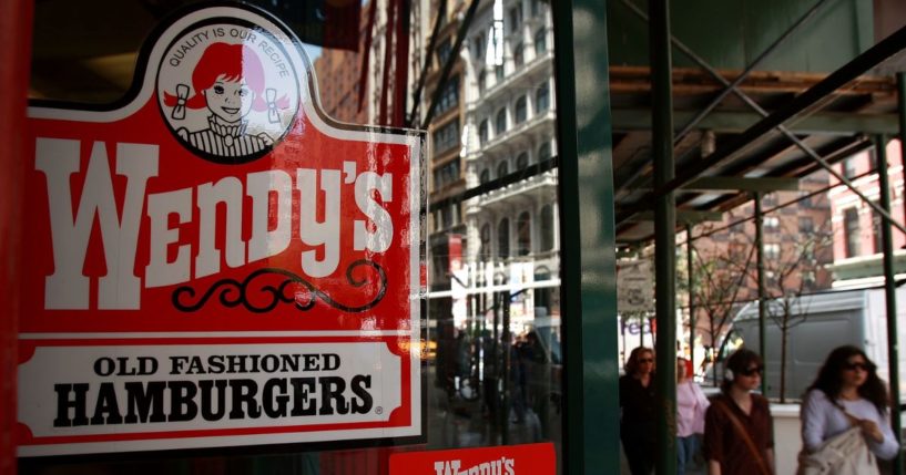 Pedestrians walk by a Wendy's hamburger chain on April 24, 2008, in New York City.