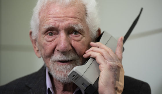 Marty Cooper, inventor of the first commercial cellphone, poses with a Motorola DynaTAC 8000X during an AP interview in Barcelona, Spain, on Monday.