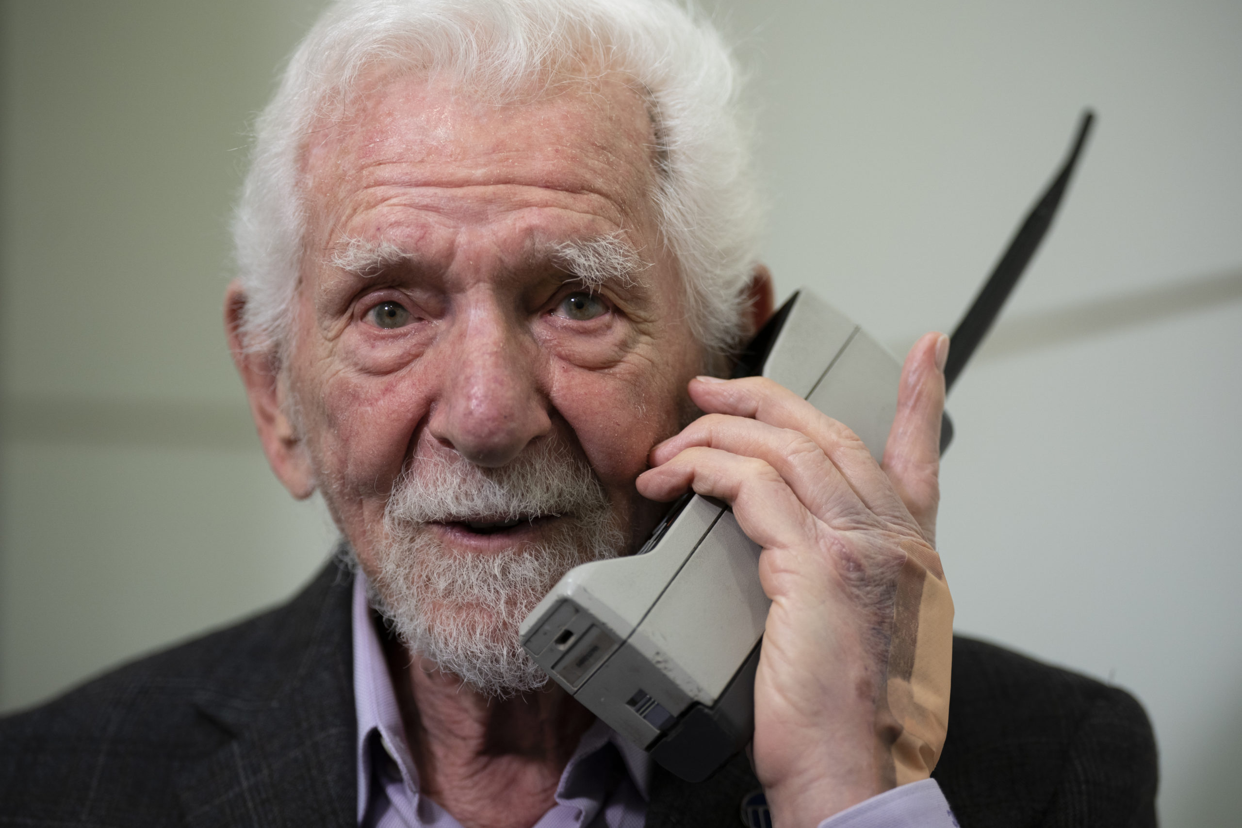 Marty Cooper, inventor of the first commercial cellphone, poses with a Motorola DynaTAC 8000X during an AP interview in Barcelona, Spain, on Monday.