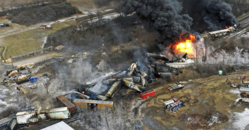 portions of a Norfolk Southern freight train that derailed in East Palestine, Ohio, on fire
