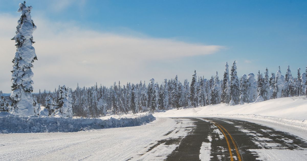 A snowy road is seen in the above stock image.