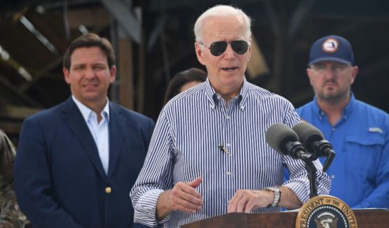 President Joe Biden is seen speaking in a neighborhood impacted by Hurricane Ian in Fort Myers, Florida, in a file photo from October. Florida Governor Ron DeSantis, left, looks on.