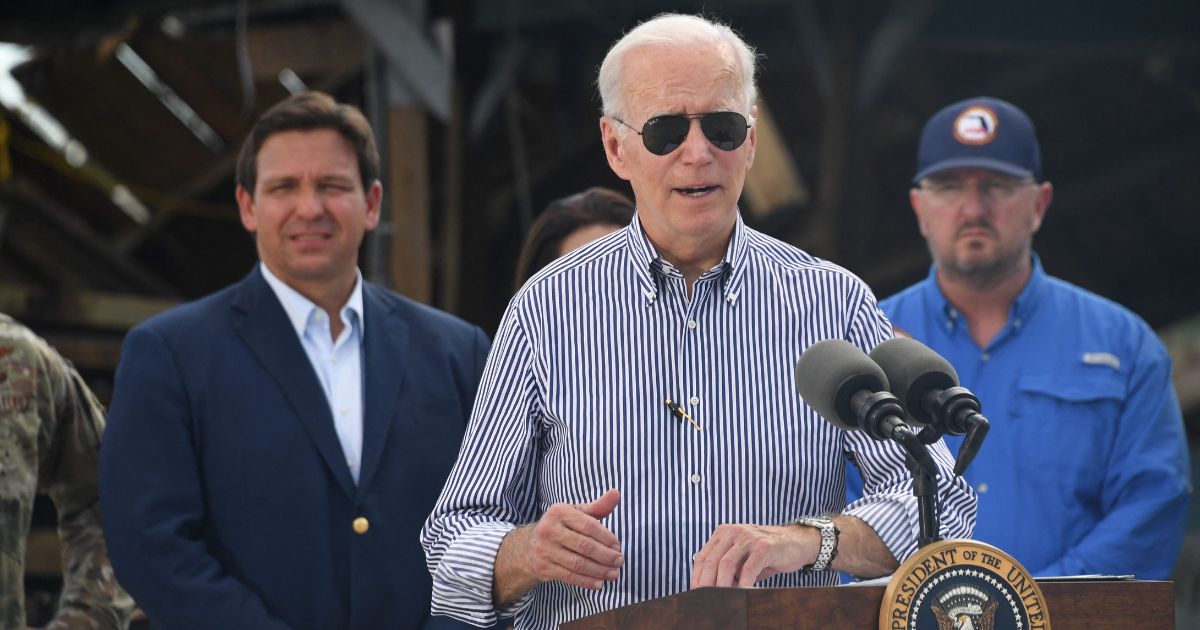 President Joe Biden is seen speaking in a neighborhood impacted by Hurricane Ian in Fort Myers, Florida, in a file photo from October. Florida Governor Ron DeSantis, left, looks on.