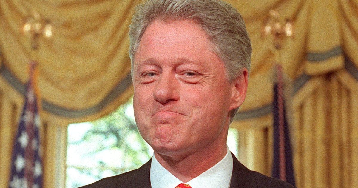 Then-President Bill Clinton smiles during a news conference in the Oval Office of the White House in Washington on April 10, 1998.