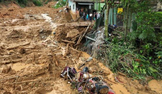 A crumpled vehicle lies in the mud after a deadly landslide triggered by heavy rains destroyed the area near Juquehy beach in the coastal city of Sao Sebastiao, Brazil, on Monday.