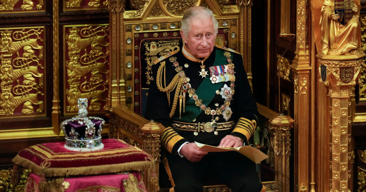 Then-Prince Charles reads the queen's speech next to her Imperial State Crown in the House of Lords Chamber during the State Opening of Parliament in the House of Lords at the Palace of Westminster in London on May 10, 2022.