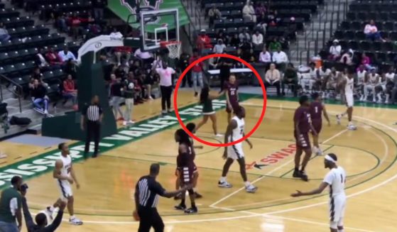 The cheerleader walked onto the court to confront a player from the opposing team.