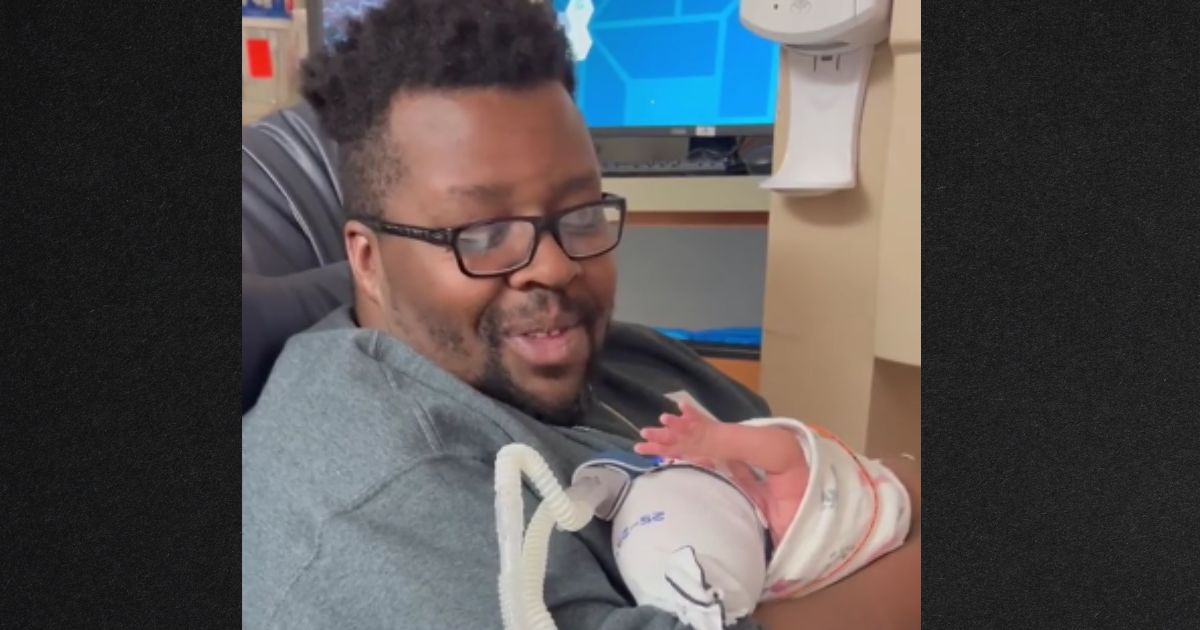 Texas dad Daniel Johnson sings to his son Remington, who was born 4 months prematurely.