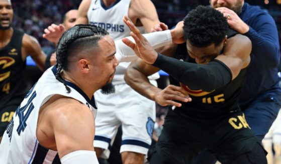 Dillon Brooks of the Memphis Grizzlies fights with Donovan Mitchell of the Cleveland Cavaliers during the third quarter of a game at Rocket Mortgage Fieldhouse on Thursday in Cleveland, Ohio.