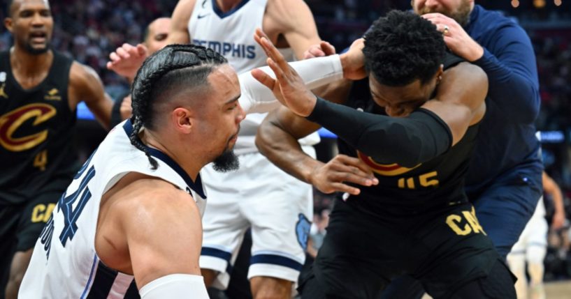 Dillon Brooks of the Memphis Grizzlies fights with Donovan Mitchell of the Cleveland Cavaliers during the third quarter of a game at Rocket Mortgage Fieldhouse on Thursday in Cleveland, Ohio.