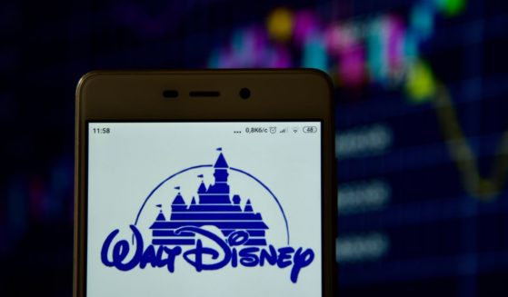 The Disney logo is displayed on a cellphone screen in this stock image.