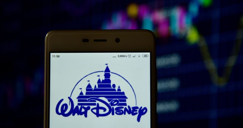 The Disney logo is displayed on a cellphone screen in this stock image.