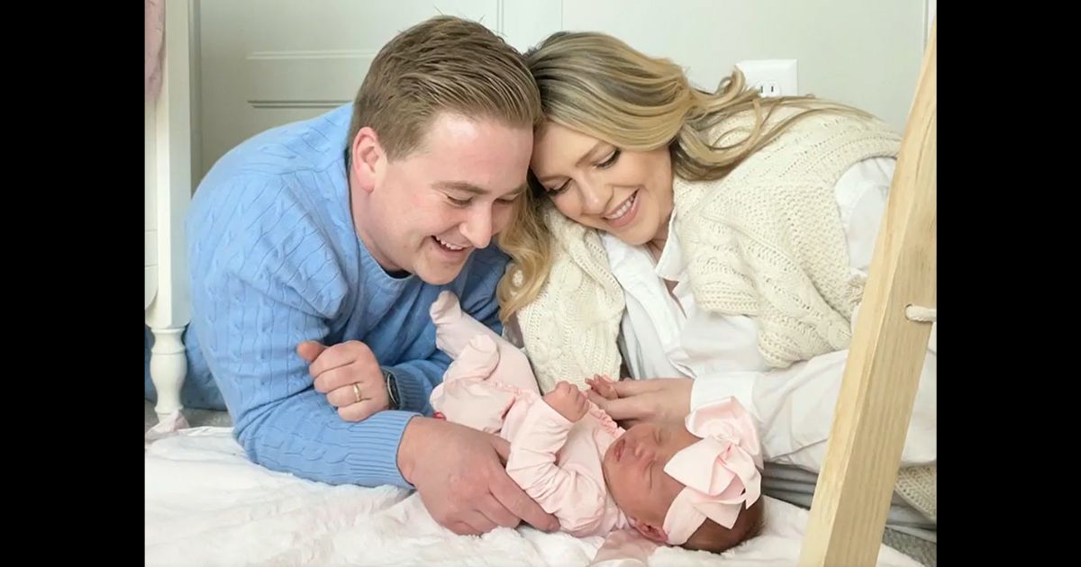 Fox News White House correspondent Peter Doocy and his wife, Hillary Vaughn, look at their new baby girl, Bridget.
