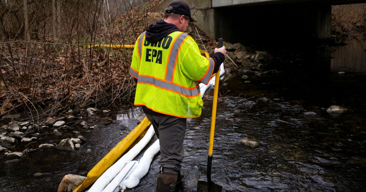 Ron Fodo with Ohio EPA Emergency Response checks the Leslie Run creek for signs of chemicals in the water in East Palestine, Ohio, on Feb. 20.