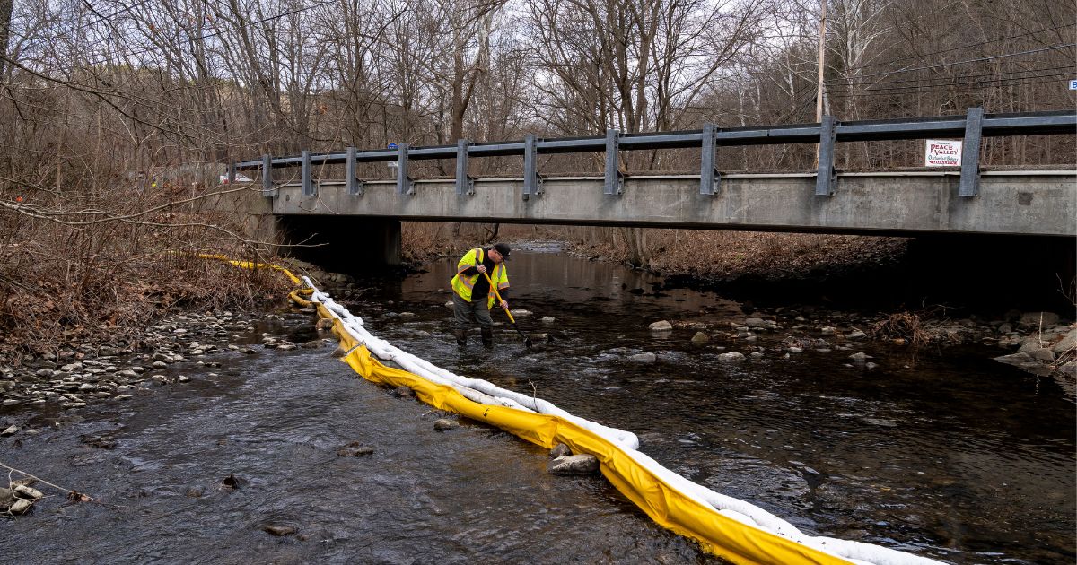 Ron Fodo, Ohio EPA Emergency Response, looks for signs of fish and also agitates the water in Leslie Run Creek Monday to check for chemicals that have settled at the bottom following the Feb. 3 train derailment prompting health concerns in East Palestine, Ohio.