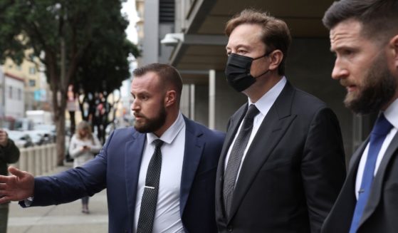 Tesla CEO Elon Musk, center, leaves court on Friday in San Francisco.