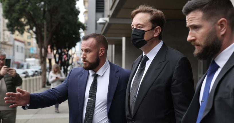Tesla CEO Elon Musk, center, leaves court on Friday in San Francisco.
