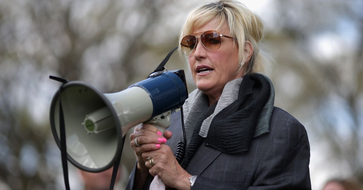 Erin Brockovich addresses the crowd at a rally against federal government support for a "known polluter" in Washington, D.C., on April 23, 2014.