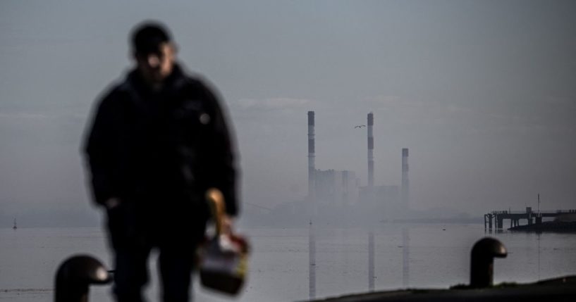 A man walks in front of the Cordemais coal power plant in France on Jan. 20.