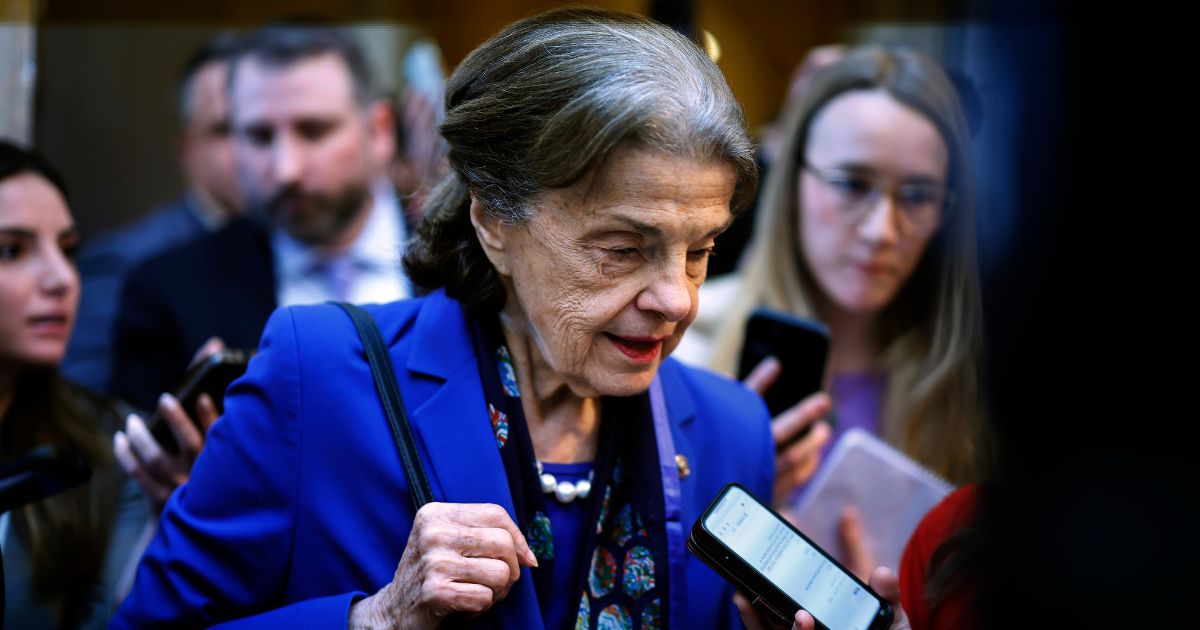 Democratic Sen. Dianne Feinstein of California is surrounded by reporters as she heads to the Senate Chamber for a vote at the U.S. Capitol in Washington on Tuesday.