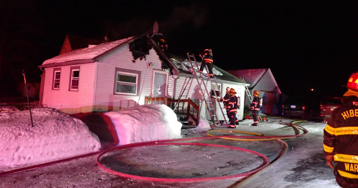 Members of the Hibbing Fire Department in Minnesota battle a house blaze on Sunday.