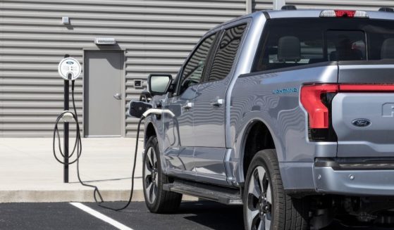A Ford F-150 Lightning electric pickup is seen at a charger in June 2022.