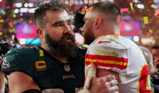 Philadelphia Eagles' Jason Kelce, left, speaks to his brother Travis Kelce, right, of the Kansas City Chiefs after the Super Bowl on Sunday night.