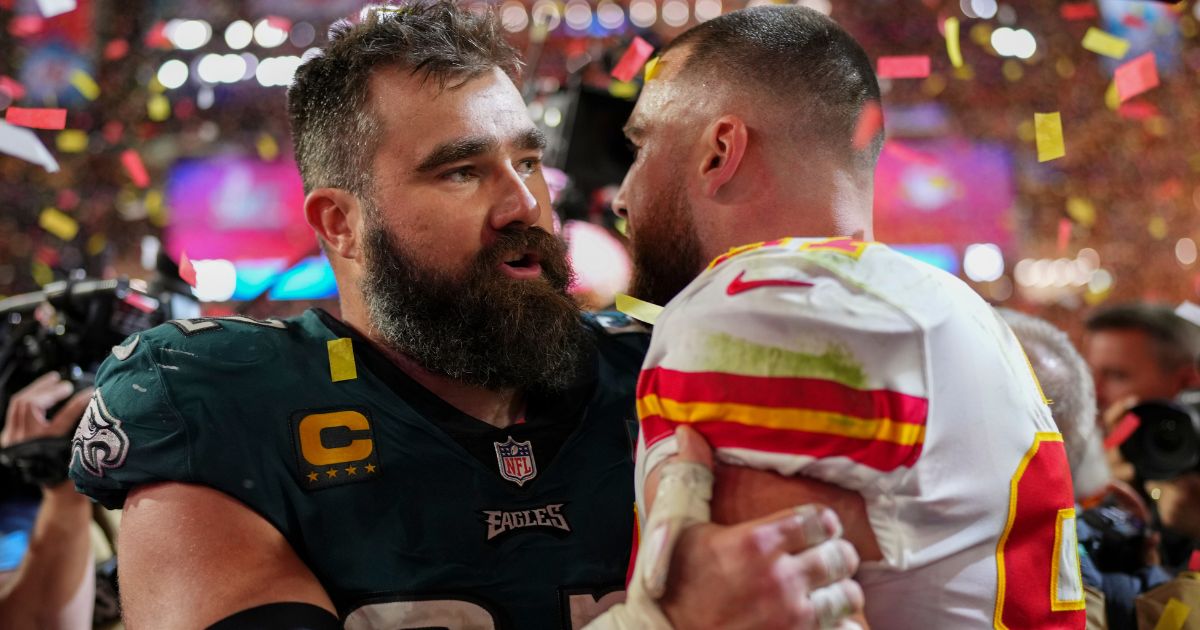 Philadelphia Eagles' Jason Kelce, left, speaks to his brother Travis Kelce, right, of the Kansas City Chiefs after the Super Bowl on Sunday night.