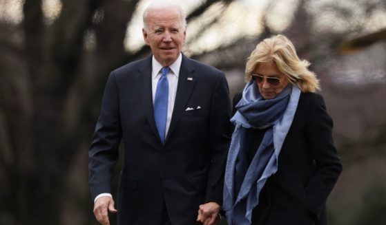 President Joe Biden, left, and first lady Jill Biden, right, walk on the South Lawn after they returned to the White House in Washington, D.C., on Jan. 23.