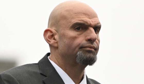 Sen. John Fetterman of Pennsylvania stands during the singing of the national anthem before Josh Shapiro is sworn in as governor of Pennsylvania at the State Capitol in Harrisburg on Jan. 17.