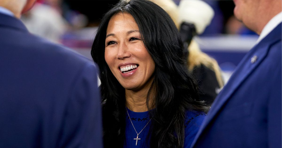 Buffalo Bills owner Kim Pegula visits with Dallas Cowboys owner Jerry Jones and son Stephen Jones before the two teams' game in Arlington, Texas, on Nov. 28, 2019.