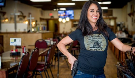 Lauren Boebert poses for a portrait at Shooters Grill in Rifle, Colorado in a file photo from 2018. Now a U.S. Representative, Boebert has cosponsored a new bill to make the AR-15 the national gun of the United States.