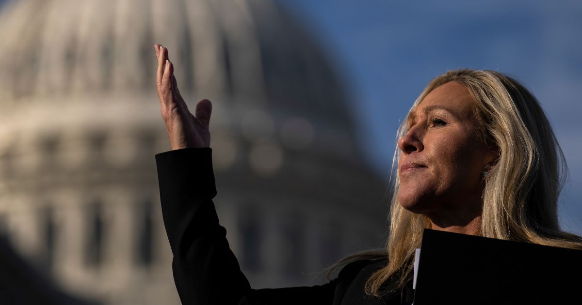 Rep. Marjorie Taylor Greene (R-GA) gestures toward an aide during a news conference outside the U.S. Capitol on February 1, 2023 in Washington, DC.