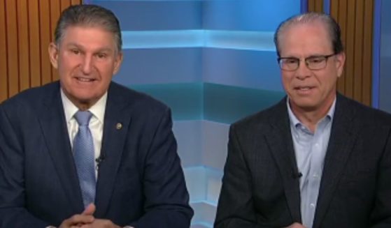 Sen. Joe Manchin, left, and Sen. Mike Braun plan to introduce a resolution to roll back a new Biden administration rule that allows investment managers to prioritize ESG criteria over return on investment for retirement accounts.