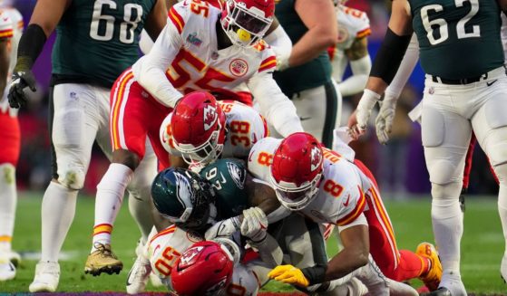 A host of Kansas City Chiefs tackle Miles Sanders of the Philadelphia Eagles during Super Bowl LVII on Feb. 12.
