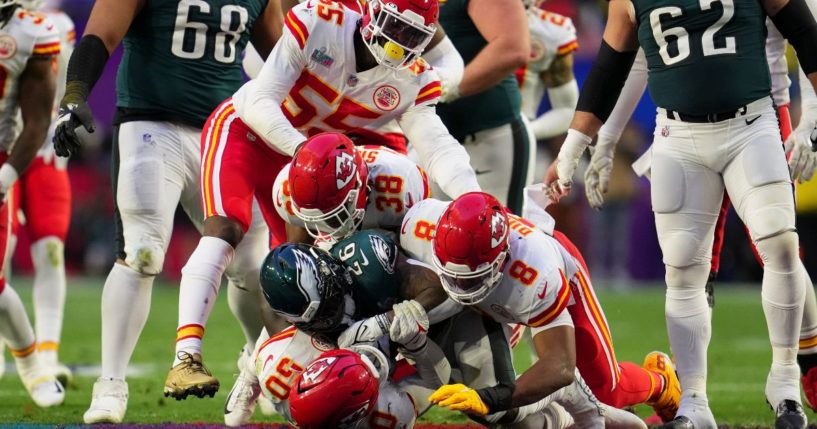 A host of Kansas City Chiefs tackle Miles Sanders of the Philadelphia Eagles during Super Bowl LVII on Feb. 12.
