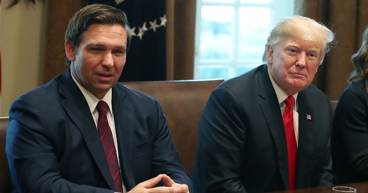 Florida Gov.-elect Ron DeSantis sits next to President Donald Trump in the Cabinet Room at the White House on Dec. 13, 2018, in Washington, D.C.