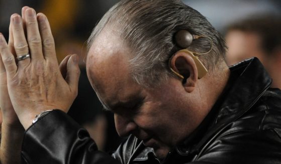 Rush Limbaugh thanks the crowd as they cheer him on as he stand on the sideline before an NFL game between the Baltimore Ravens and Pittsburgh Steelers at Heinz Field in Pittsburgh Pennsylvania, on Nov. 6, 2011.